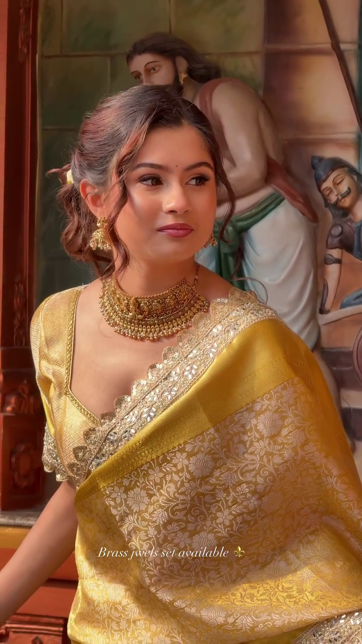 Elegant Gold Banarasi Saree with Traditional Brass Jewelry